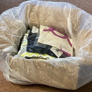 Box of brand new baby clothes